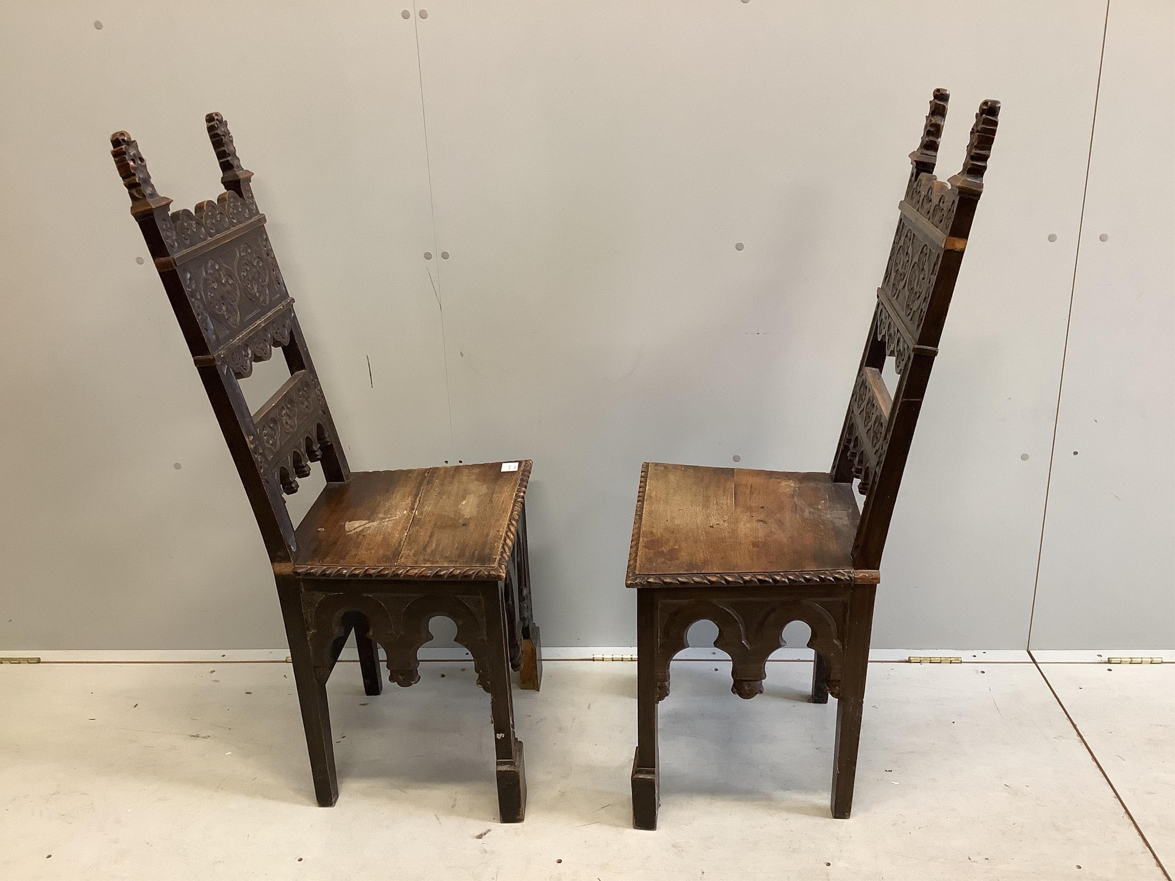 A pair of 19th century Italian walnut hall chairs, width 48cm, depth 39cm, height 118cm. Condition - fair